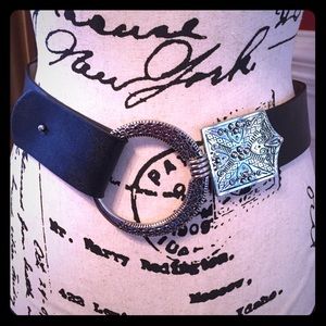 Adjustable belt with ornate silver buckle